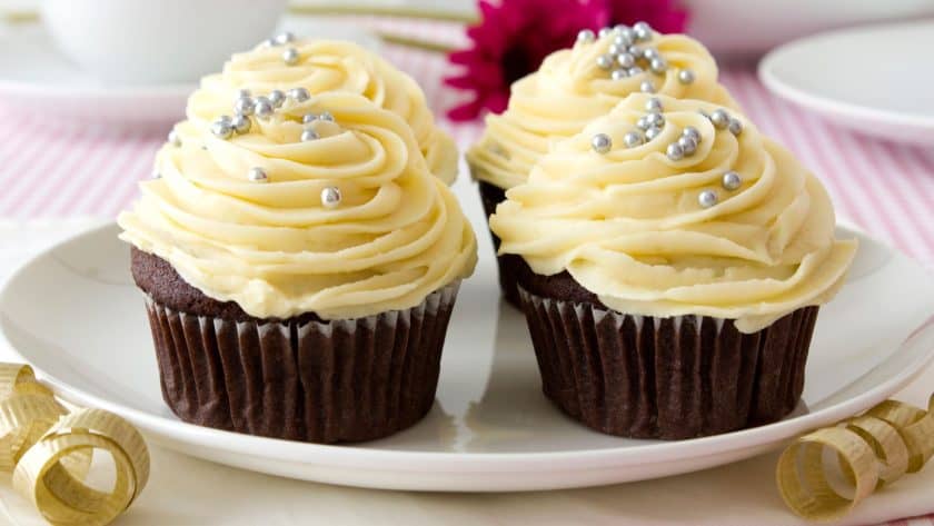 Two decorated chocolate cupcakes on plate