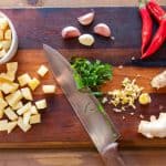 Chopped vegetables and herbs on board