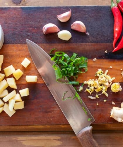 Chopped vegetables and herbs on board