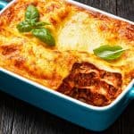 Baked lasagna with cheese and basil