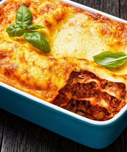 Baked lasagna with cheese and basil