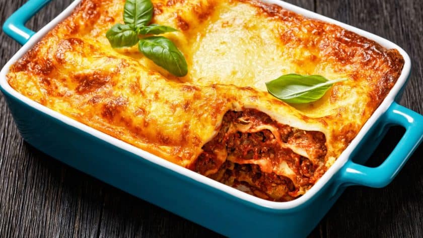 Baked lasagna with cheese and basil