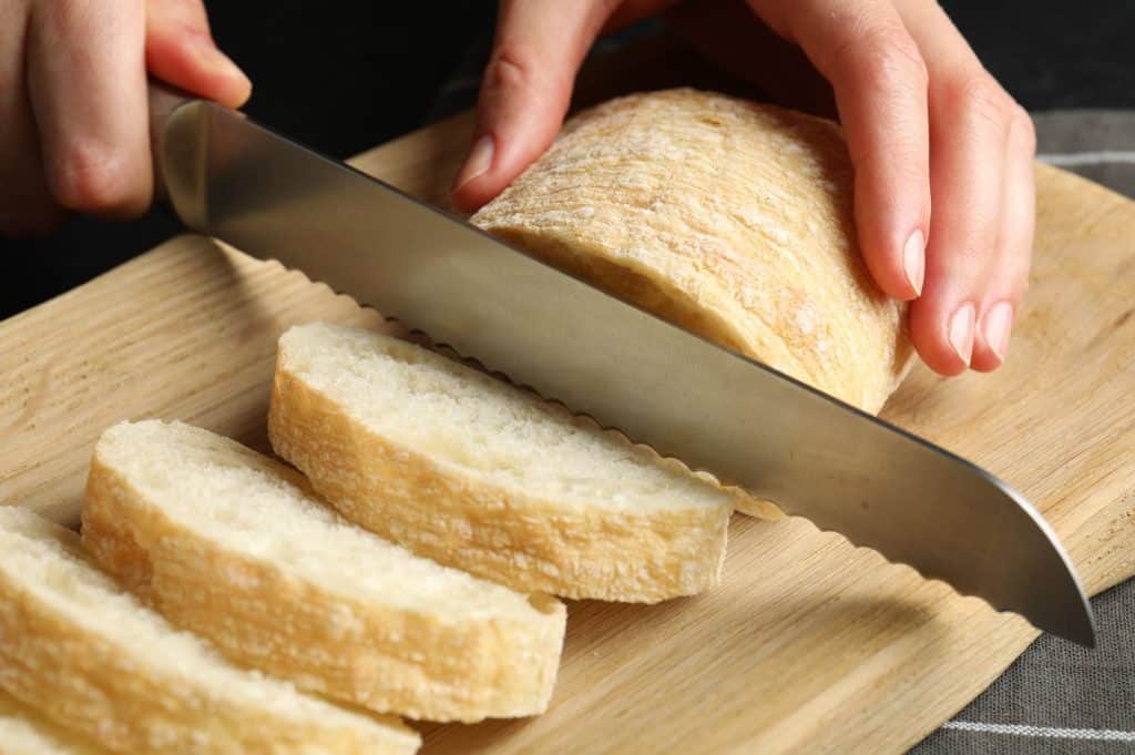 Slicing fresh bread on a board
