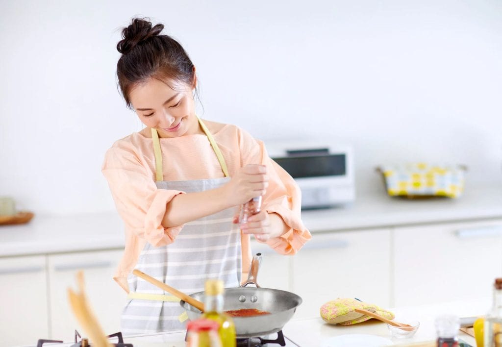Person cooking in modern kitchen.