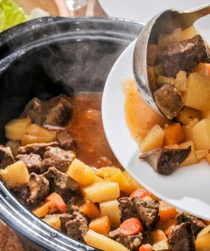 Serving beef casserole with vegetables