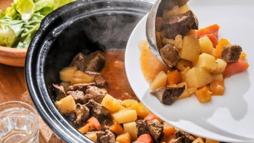 Serving beef casserole with vegetables