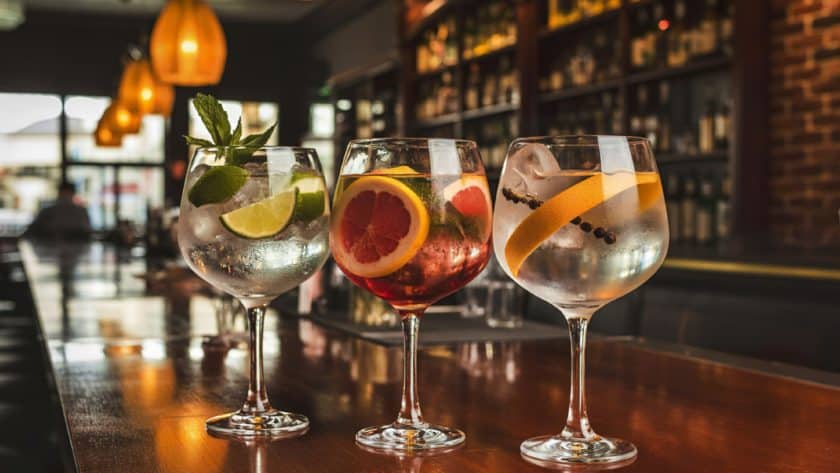 Three colorful cocktails on bar