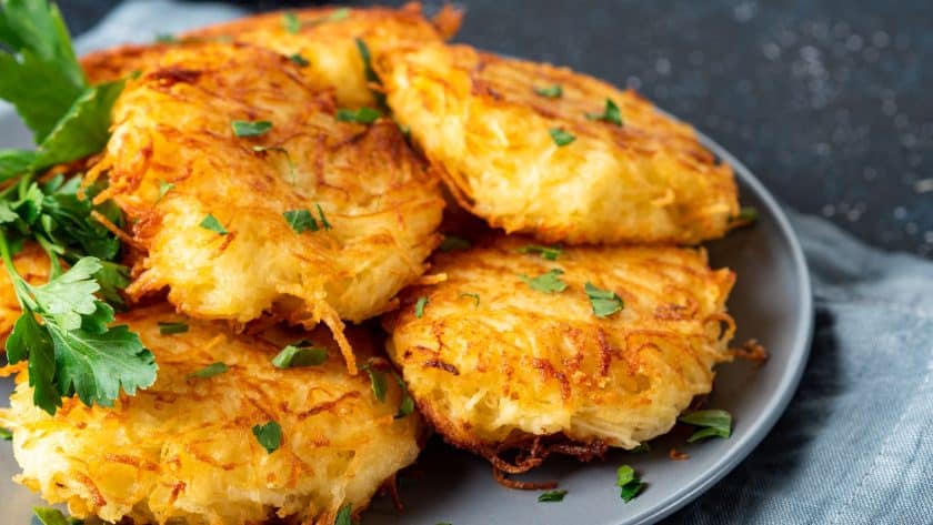Crispy golden hash browns on plate
