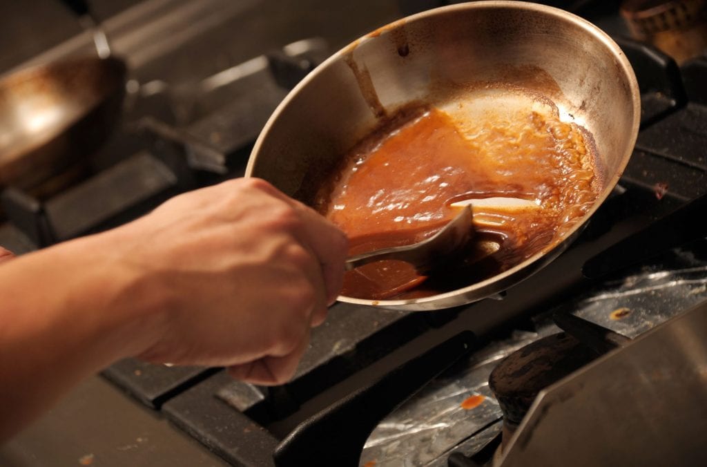 Stirring sauce in a pan