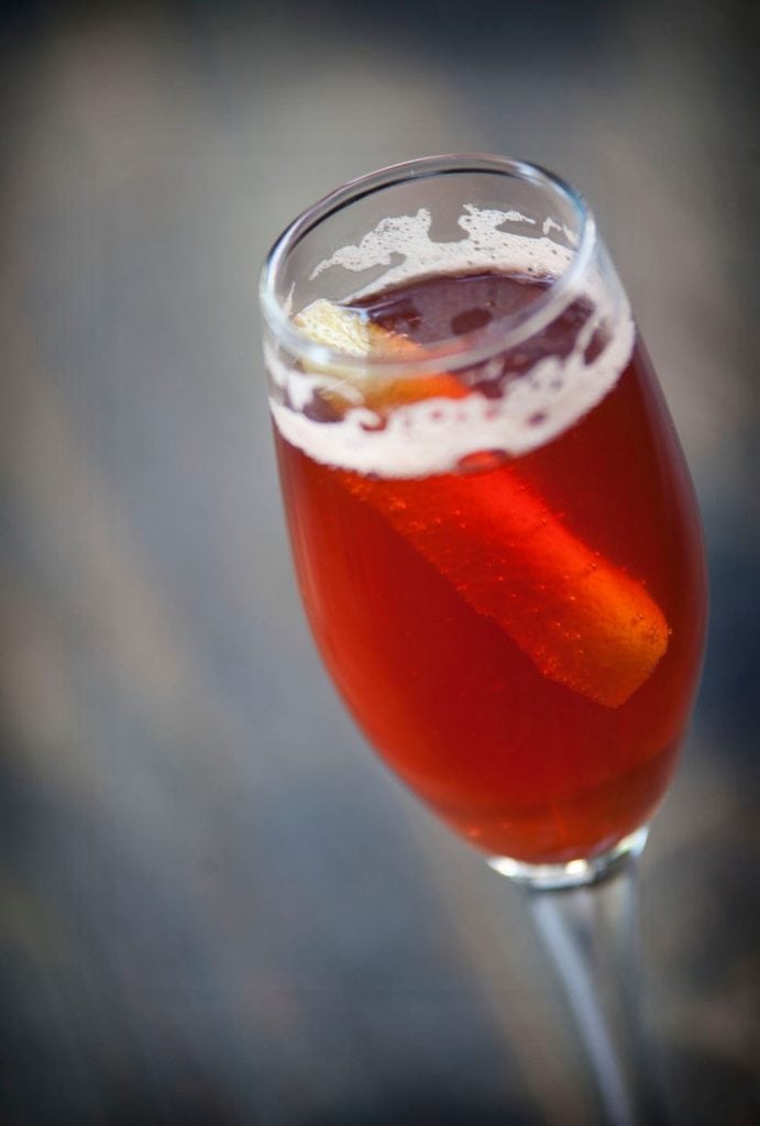 Red cocktail in a champagne flute