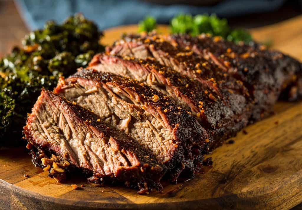 Sliced beef brisket on wooden board