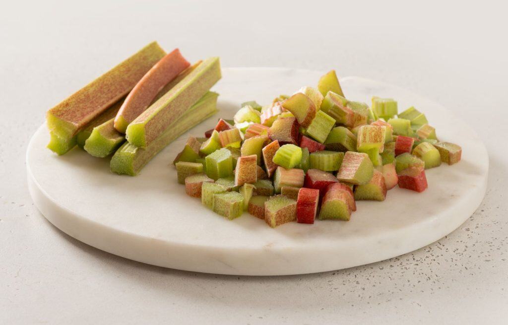 Chopped rhubarb on a marble surface.