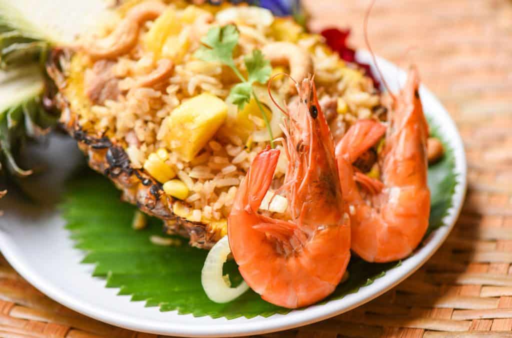 Fried rice served in pineapple with prawns