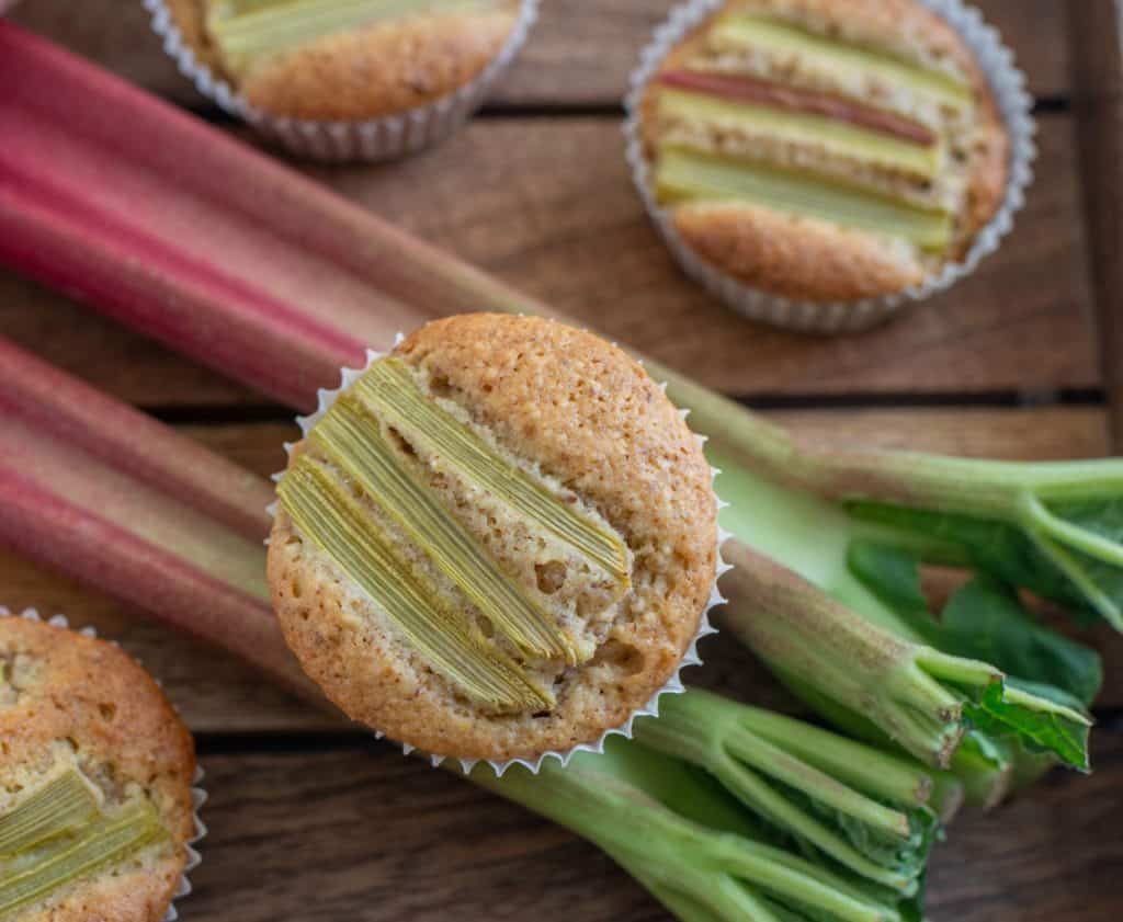 Rhubarb muffins on wooden surface