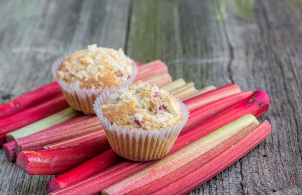 Muffins on rhubarb stalks background