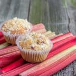 Muffins on rhubarb stalks background