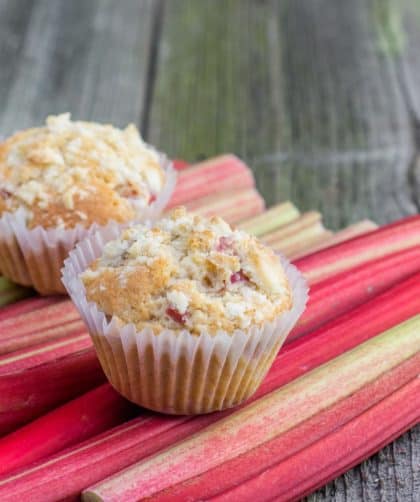 Muffins on rhubarb stalks background
