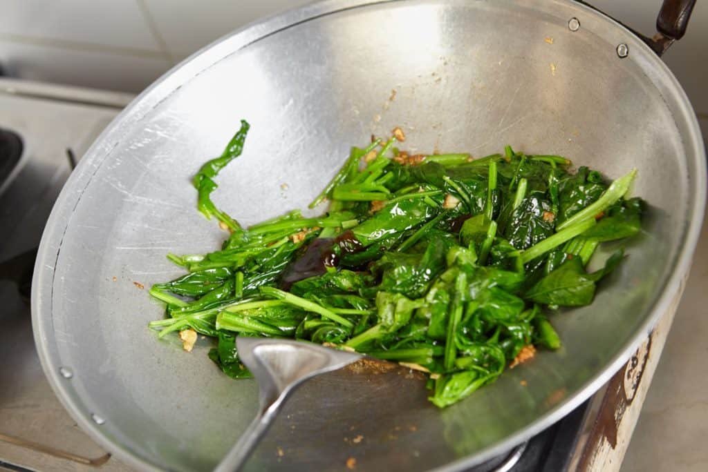 Stir-fried green vegetables in pan