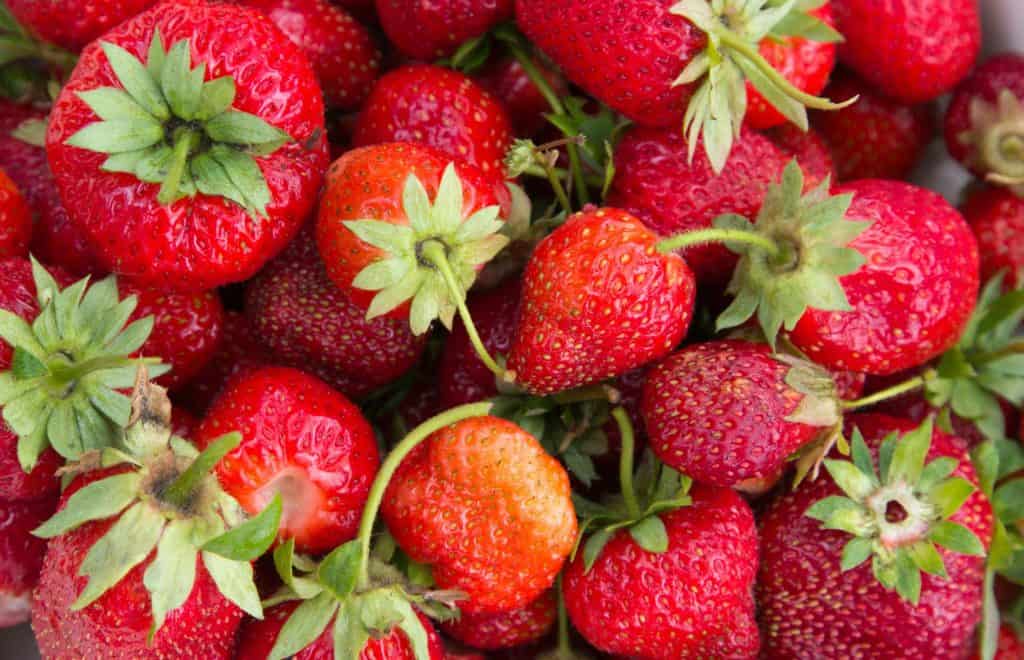 Fresh, ripe strawberries in a pile.