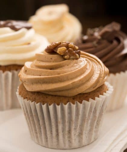 Three frosted cupcakes on napkin