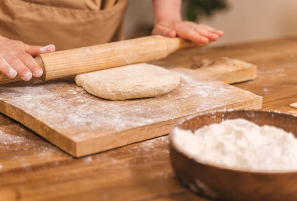 Rolling dough on a wooden surface