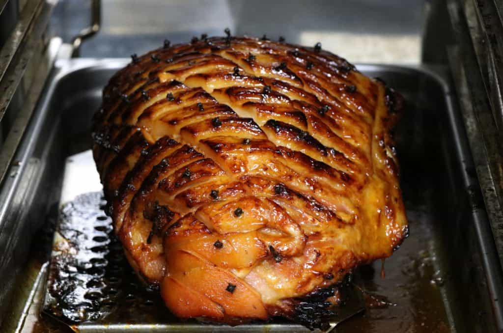 Glazed, roasted ham on tray