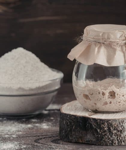 Jar of sourdough starter and flour