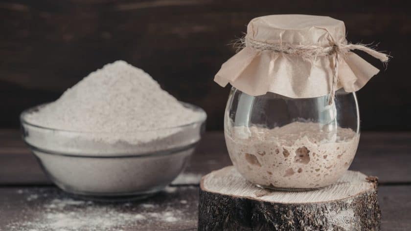 Jar of sourdough starter and flour