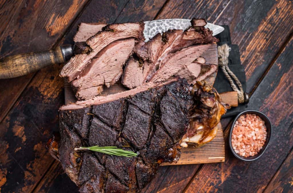 Sliced venison on wooden cutting board