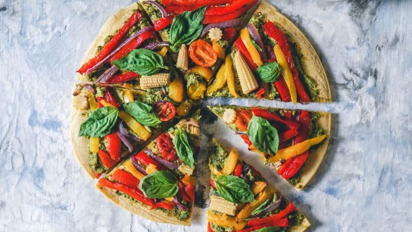 Colorful vegetable-topped pizza slices